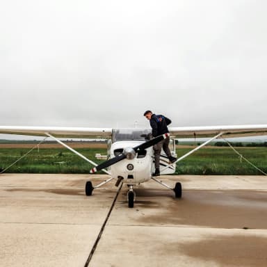 man refueling a Cessna airplane on the ground