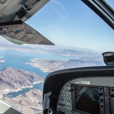 photography through the windshield of a small airplane flying over a desert